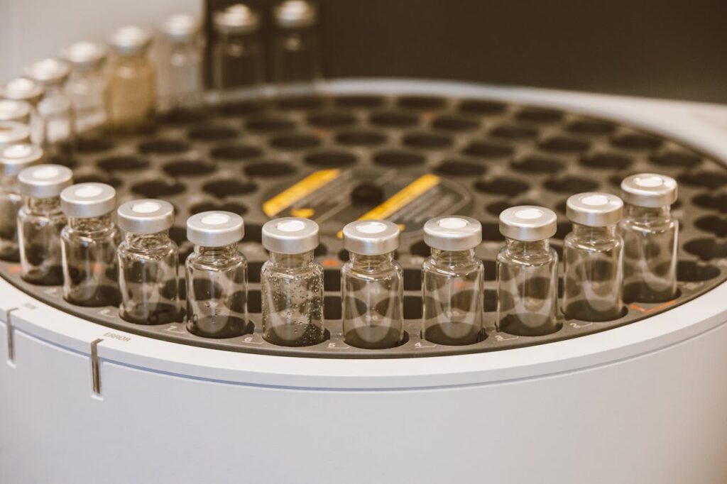 pexels-photo-9259963 An array of glass vials in a lab setting, ideal for scientific research visuals.